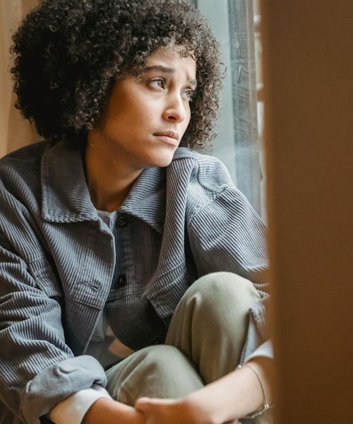Woman feeling energized and light after a gentle cardio session indoors.